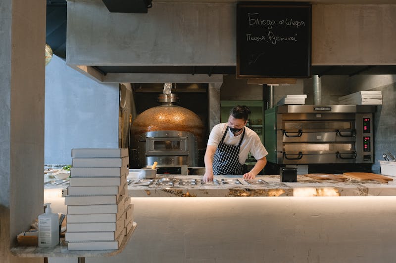 Open kitchen pizza bar where chefs craft pizzas